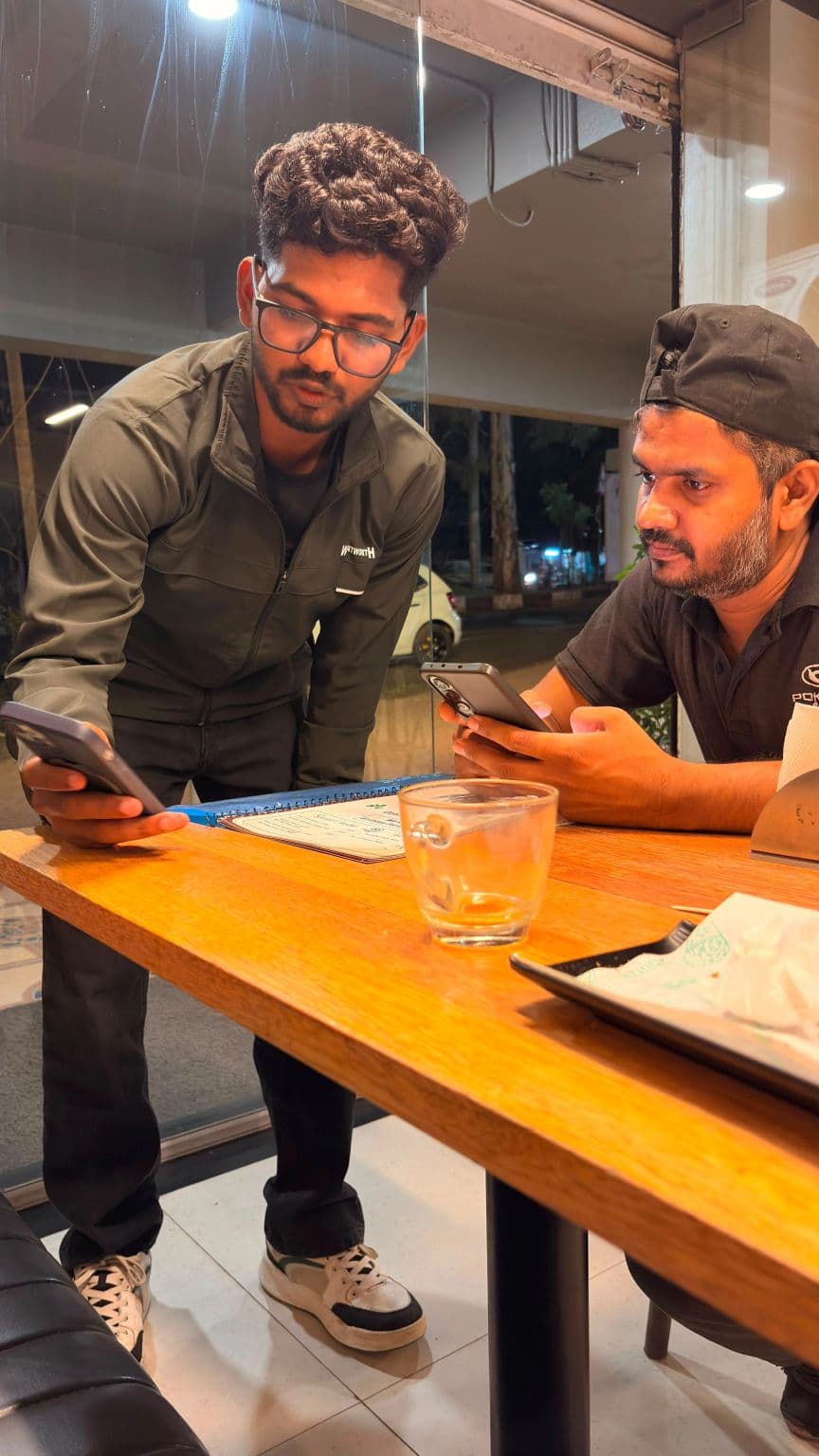 A Nukaazo team member helping a shop owner get set up on his phone