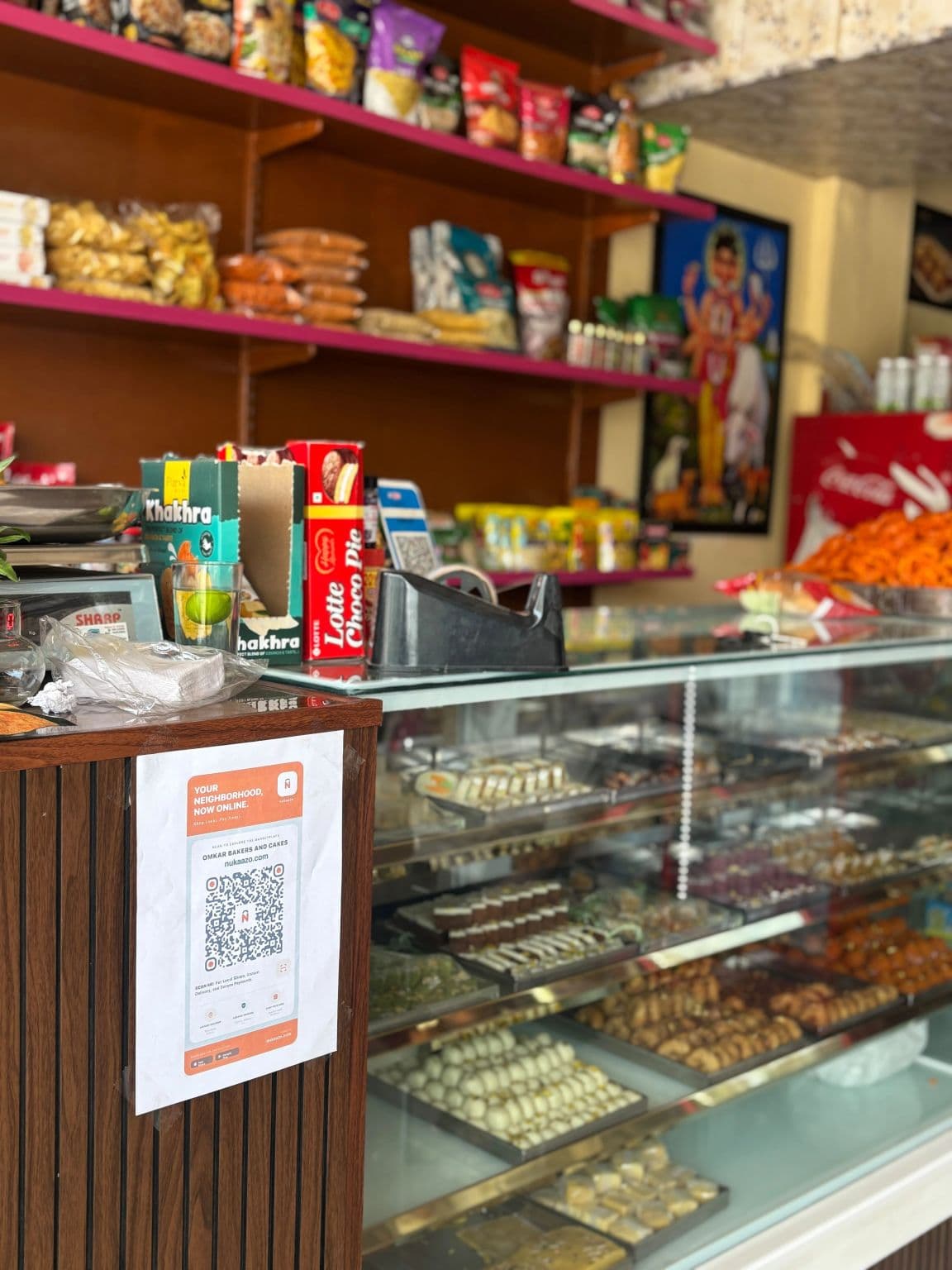A Nukaazo QR code displayed on the counter of a neighbourhood sweet shop